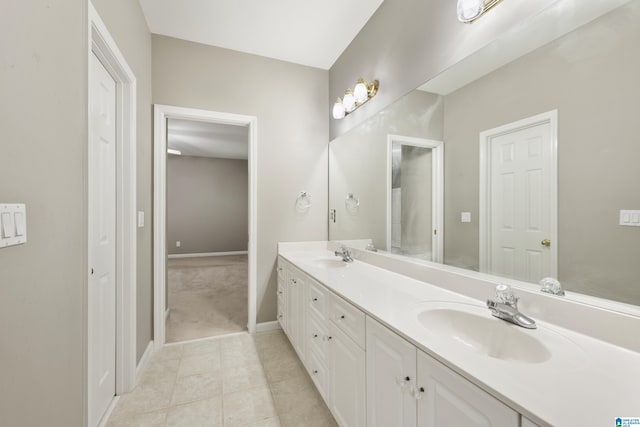 43 Dogwood Dr, Calera, AL 35040 - bathroom with double vanity, baseboards, a sink, and tile patterned flooring