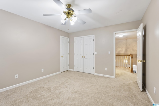43 Dogwood Dr, Calera, AL 35040 - unfurnished bedroom with a closet, baseboards, a ceiling fan, and light colored carpet