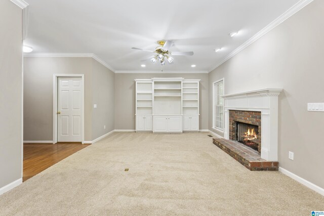 43 Dogwood Dr, Calera, AL 35040 - unfurnished living room featuring crown molding, a brick fireplace, ceiling fan, and light carpet