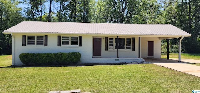 single story home with a front lawn, driveway, a carport, brick siding, and metal roof