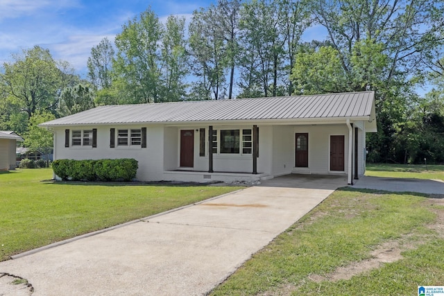 single story home with driveway, a front yard, an attached carport, and metal roof