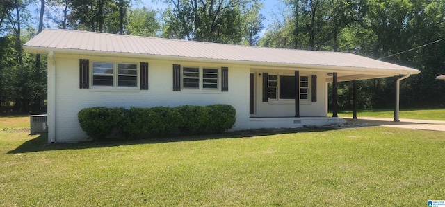 single story home with brick siding, a front yard, an attached carport, and metal roof