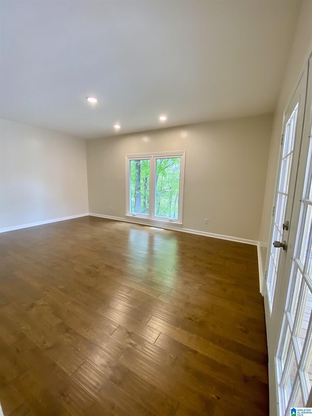 spare room featuring french doors, baseboards, recessed lighting, and dark wood-type flooring