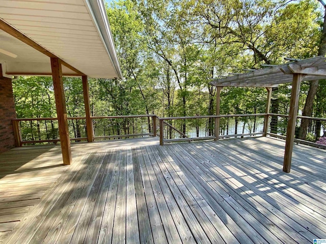 wooden terrace featuring a pergola and a water view