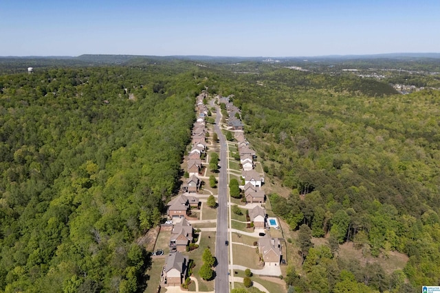 aerial view featuring a forest view and a residential view