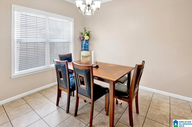 dining room featuring a chandelier, baseboards, and light tile patterned floors
