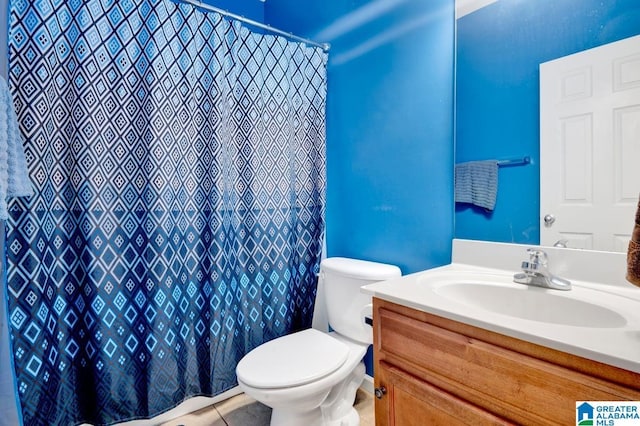 bathroom with tile patterned flooring, toilet, vanity, and a shower with shower curtain