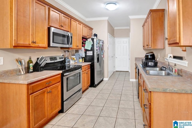 kitchen featuring a sink, light tile patterned floors, stainless steel appliances, light countertops, and ornamental molding
