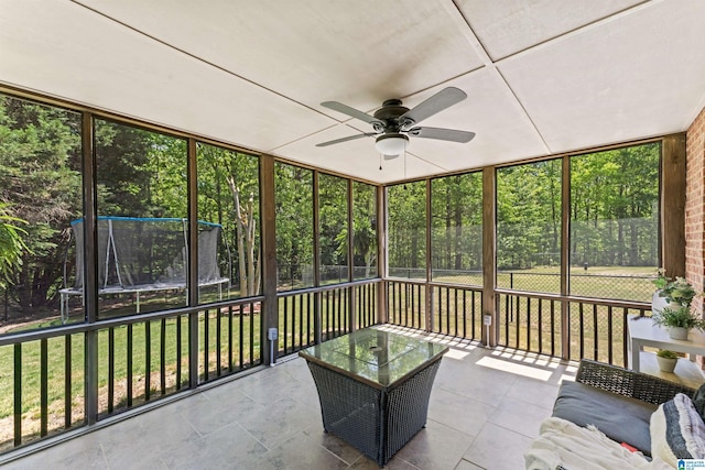 unfurnished sunroom featuring ceiling fan
