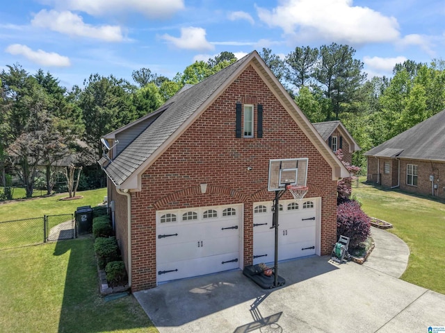 view of side of property featuring roof with shingles, fence, concrete driveway, brick siding, and a lawn