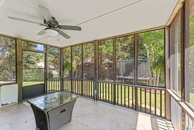 unfurnished sunroom with a ceiling fan