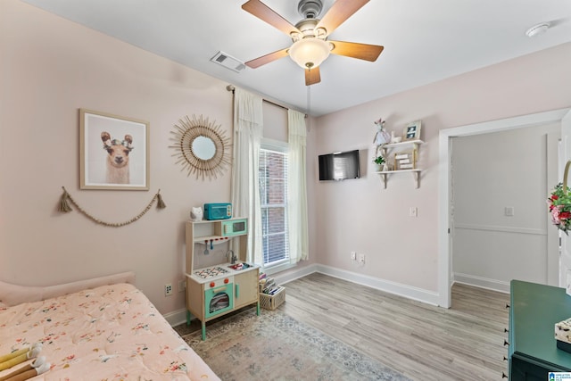 bedroom featuring wood finished floors, visible vents, baseboards, and ceiling fan
