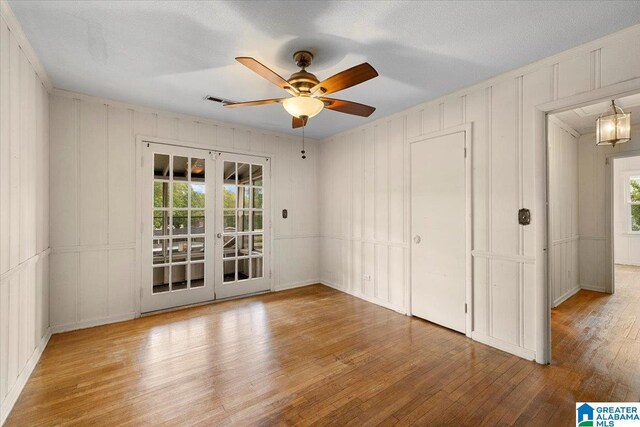 1203 Park Ave, Oneonta, AL 35121 - interior space with access to exterior, french doors, hardwood / wood-style flooring, and a decorative wall