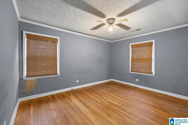 1203 Park Ave, Oneonta, AL 35121 - unfurnished room featuring visible vents, baseboards, a textured ceiling, hardwood / wood-style flooring, and a ceiling fan