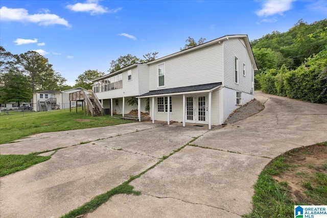 1203 Park Ave, Oneonta, AL 35121 - rear view of house featuring stairs, a lawn, french doors, and driveway