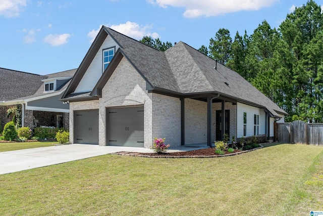 view of front of home featuring fence, a front lawn, an attached garage, driveway, and brick siding