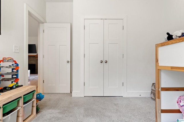 recreation room featuring carpet floors and baseboards
