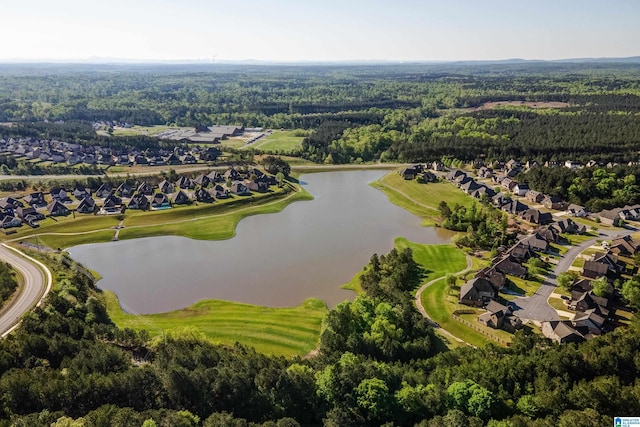 birds eye view of property featuring a residential view, a wooded view, and a water view