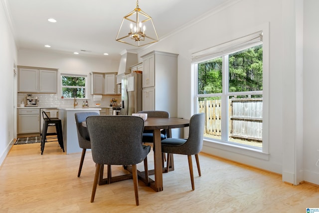 dining room with light wood-style flooring, baseboards, recessed lighting, a chandelier, and crown molding