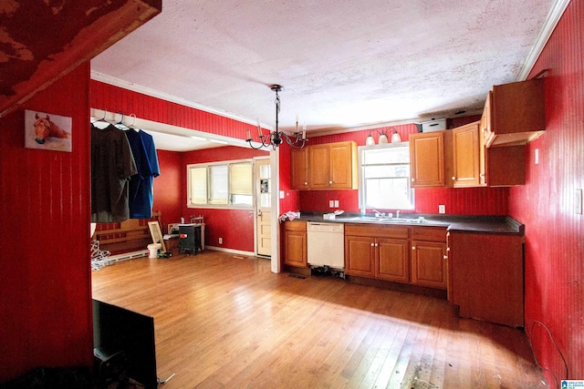 kitchen featuring dark countertops, white dishwasher, light wood finished floors, and plenty of natural light