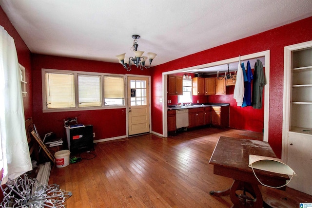 unfurnished dining area featuring baseboards, a chandelier, and dark wood-type flooring