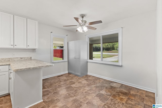 7096 US Highway 231, Cropwell, AL 35054 - unfurnished dining area with stone finish floor, visible vents, baseboards, and ceiling fan