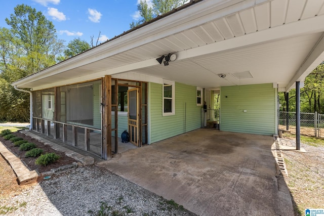7096 US Highway 231, Cropwell, AL 35054 - view of front of home featuring a sunroom, concrete driveway, fence, and an attached carport