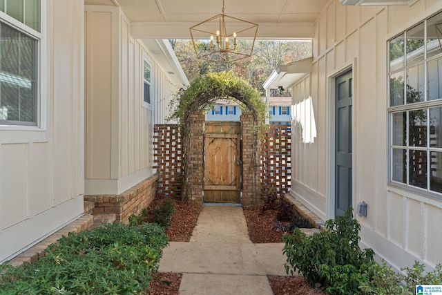 entrance to property with a gate and board and batten siding