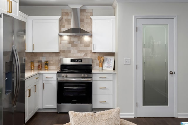 kitchen featuring stainless steel appliances, light countertops, wall chimney range hood, and decorative backsplash