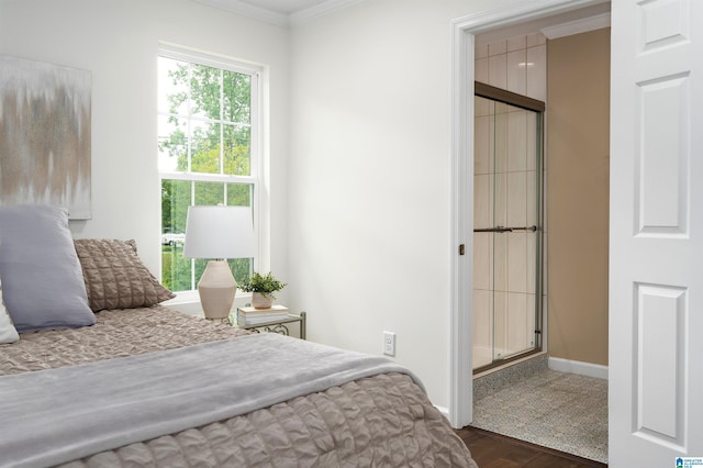 bedroom featuring crown molding, multiple windows, wood finished floors, and baseboards