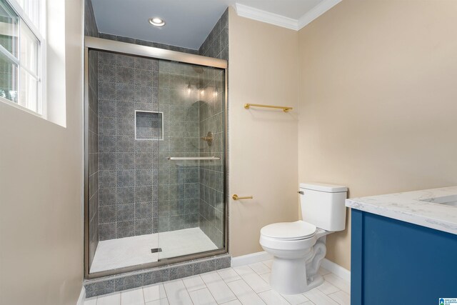 bathroom with a shower stall, baseboards, toilet, ornamental molding, and vanity