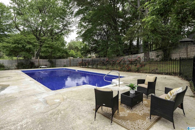 view of pool with a fenced in pool, a fenced backyard, and a patio area
