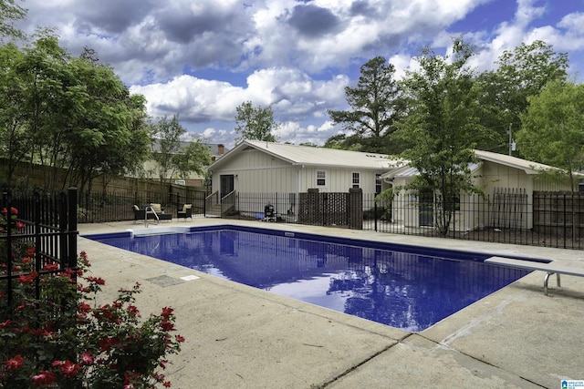 view of swimming pool featuring a diving board, a patio, fence private yard, and a fenced in pool
