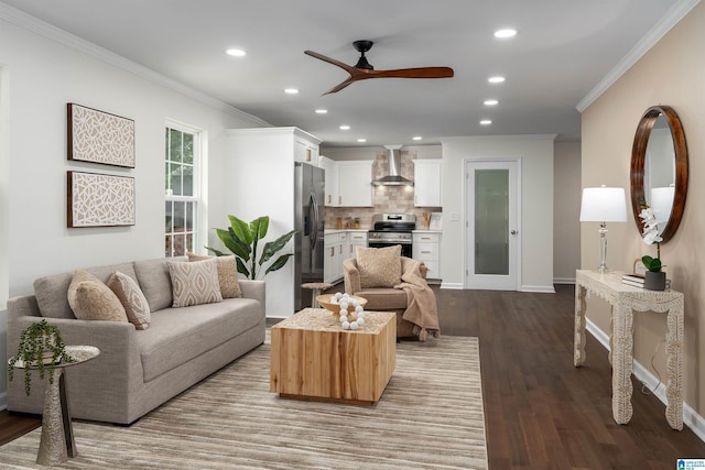 living area featuring recessed lighting, ornamental molding, a ceiling fan, and dark wood-type flooring