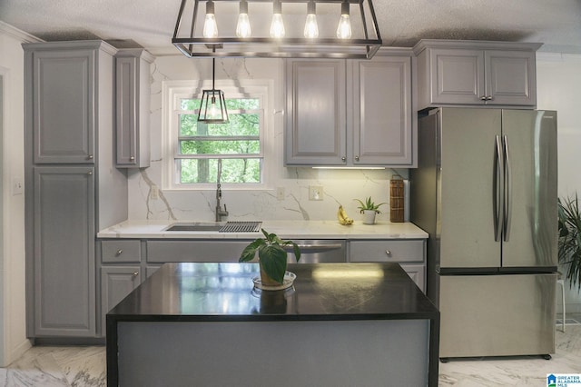 kitchen with gray cabinets, marble finish floor, appliances with stainless steel finishes, and a center island