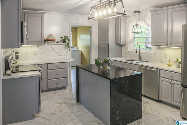 kitchen featuring washer / clothes dryer, appliances with stainless steel finishes, and gray cabinetry