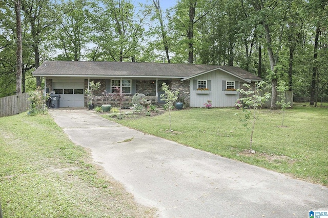 ranch-style house featuring an attached garage, fence, driveway, and a front lawn