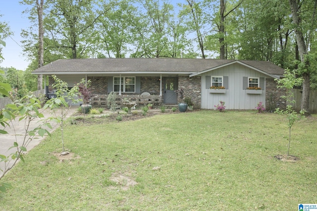 ranch-style house featuring concrete driveway, a front lawn, covered porch, and fence