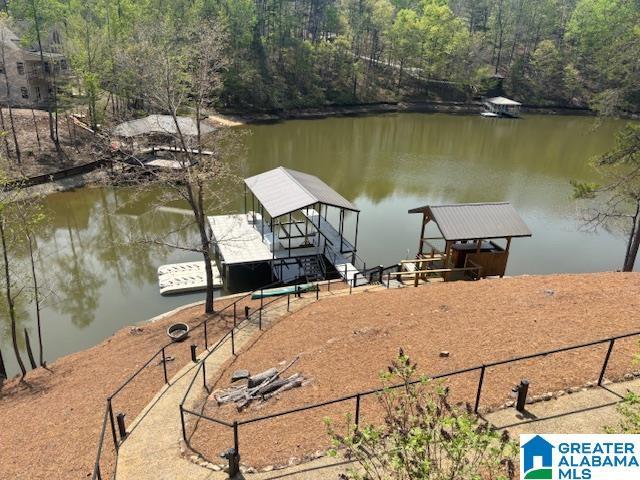 dock area featuring a water view and a view of trees