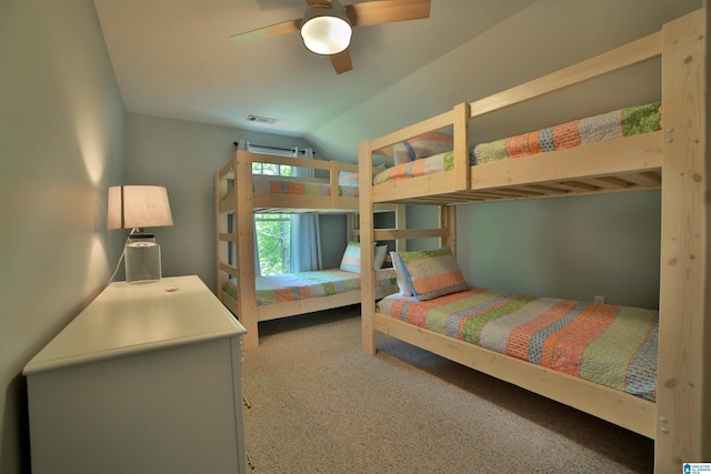 bedroom with a ceiling fan, visible vents, vaulted ceiling, and carpet