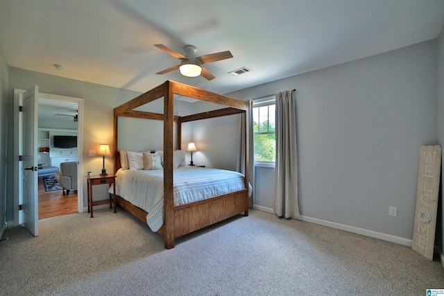bedroom featuring baseboards, visible vents, a ceiling fan, and carpet