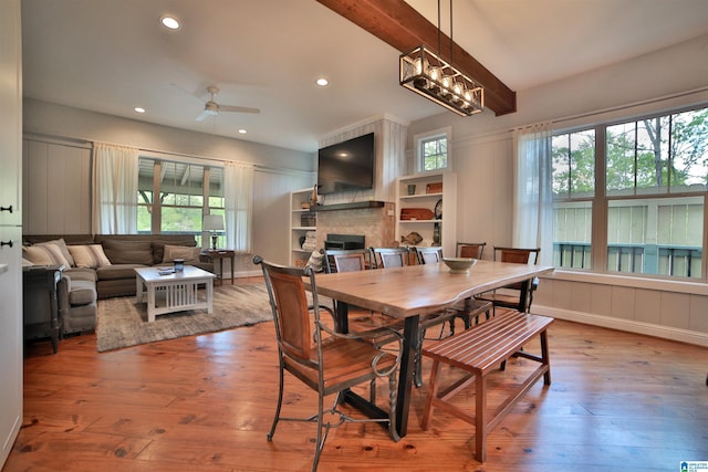 dining area featuring a fireplace, a wealth of natural light, recessed lighting, and wood-type flooring
