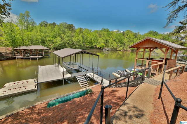 dock area featuring a water view, boat lift, and a forest view