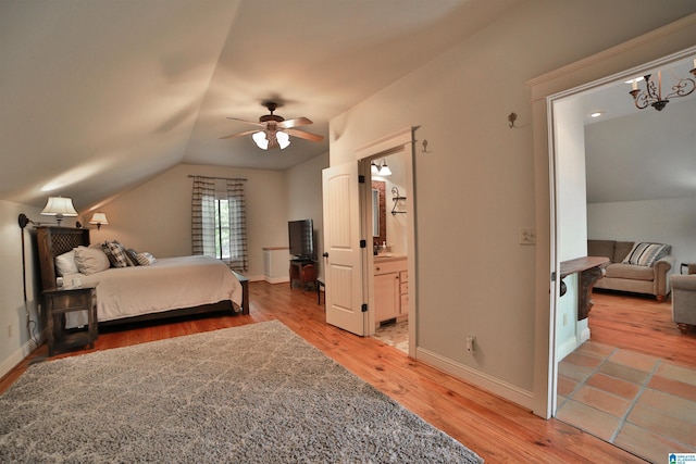 bedroom featuring wood finished floors, vaulted ceiling, and baseboards