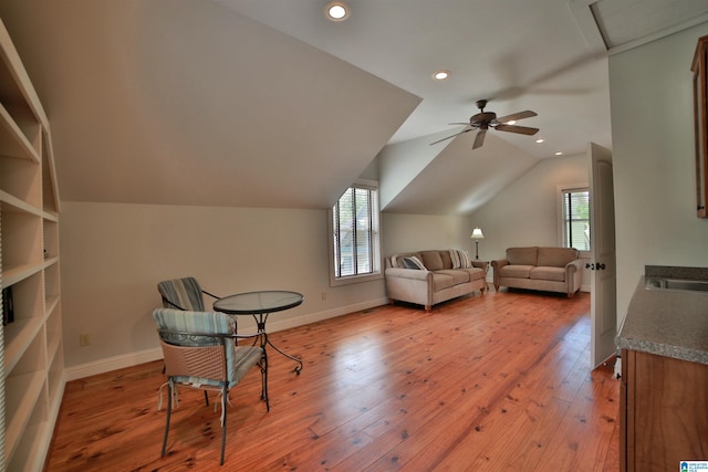 interior space with a wealth of natural light, lofted ceiling, and light wood finished floors