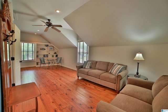 living room with ceiling fan, plenty of natural light, hardwood / wood-style floors, and vaulted ceiling