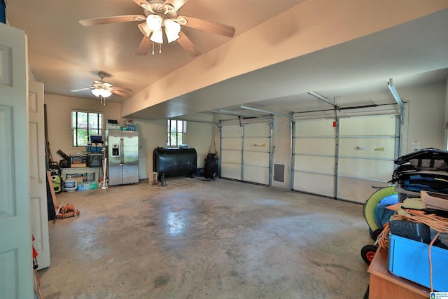garage featuring stainless steel fridge with ice dispenser and heating fuel