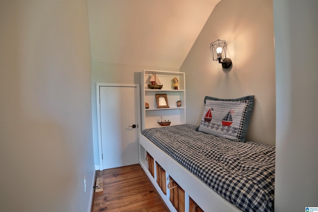 bedroom with vaulted ceiling and wood finished floors