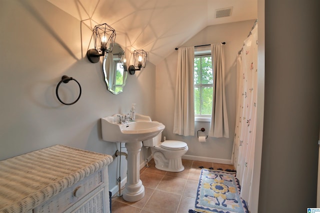 bathroom with lofted ceiling, visible vents, baseboards, toilet, and tile patterned floors