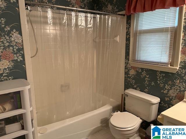full bath featuring wallpapered walls, tile patterned floors, shower / bathtub combination with curtain, toilet, and vanity